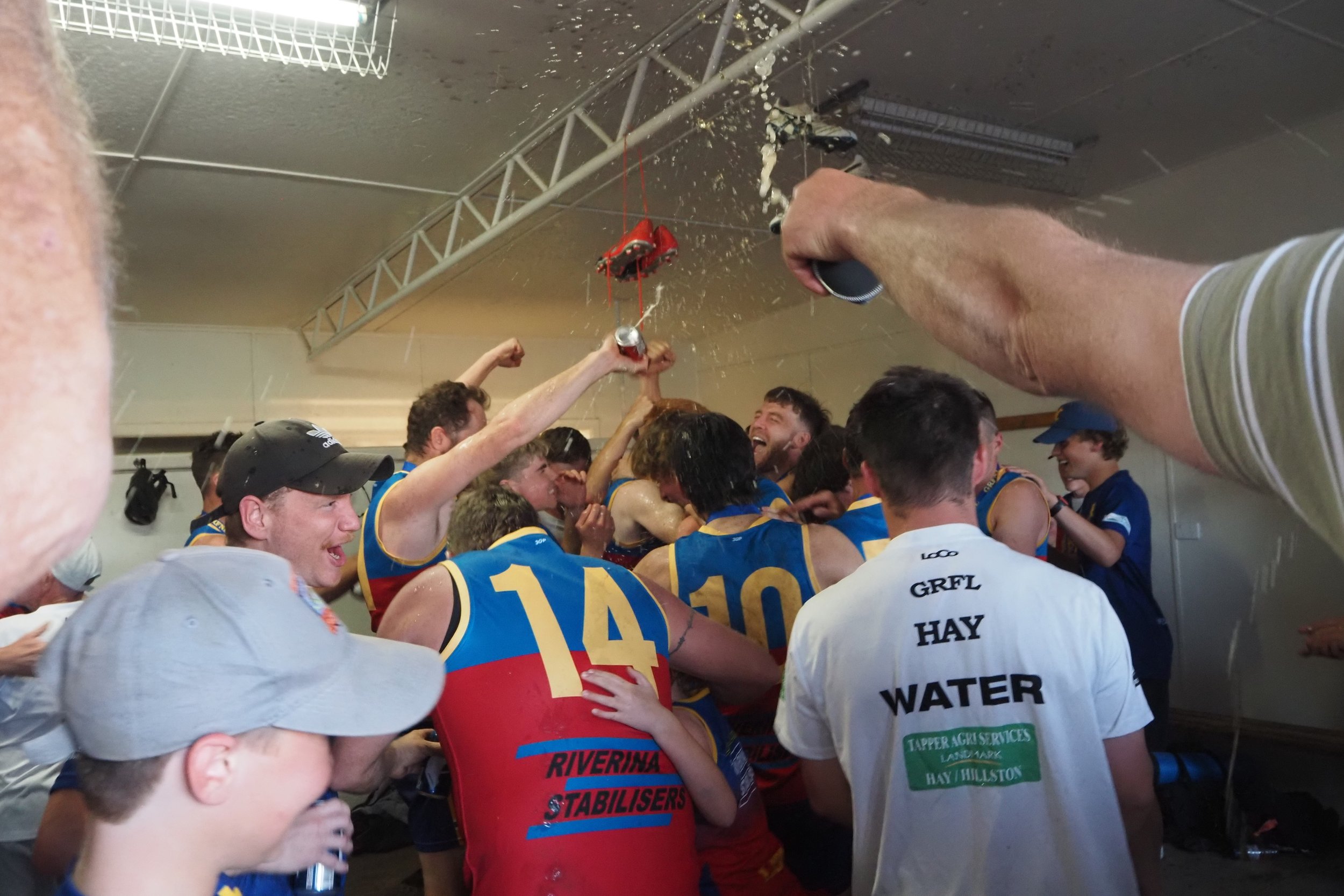 clebrating locker rooms lions grand final hay 2023.jpg